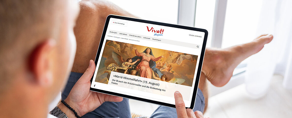 Mann bedient Tablet mit der Vivat Seite darauf